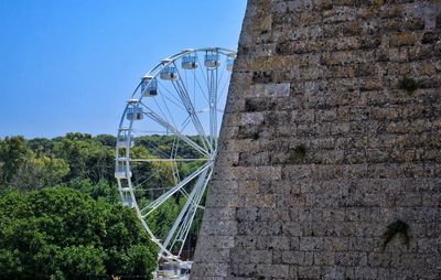 Low angle view of ferris wheel against sky