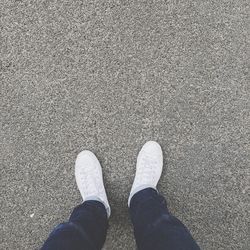 Low section of person standing on tiled floor