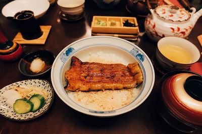 High angle view of meat on rice in bowl served at table