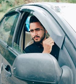 Man looking through car window