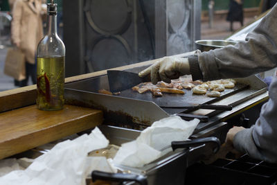 Midsection of person preparing food on cutting board