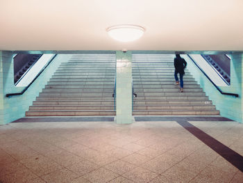 Rear view of people walking on steps