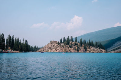 Panoramic view of lake and trees against sky