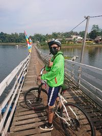 Rear view of man riding bicycle on road