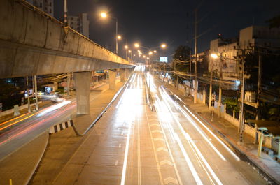 Light trails on road in city at night