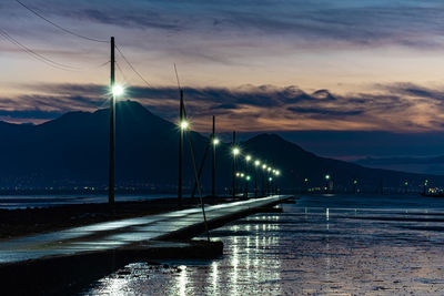 Bridge over river against sky during sunset