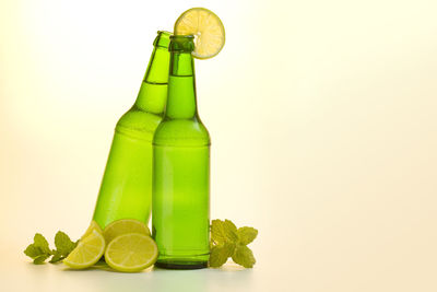 Close-up of green bottle against white background