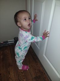 Cute girl standing on hardwood floor at home