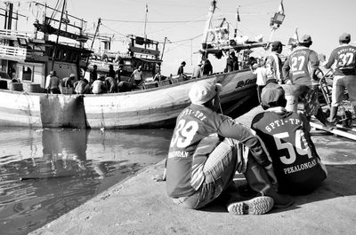 People sitting in boat against sky