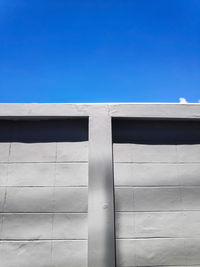 Walls and clear skies, low angle view of building against blue sky