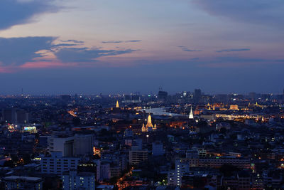 High angle view of city lit up at night