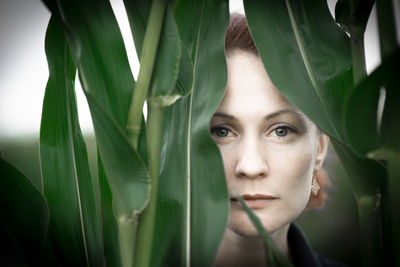 Close-up portrait of woman with leaves