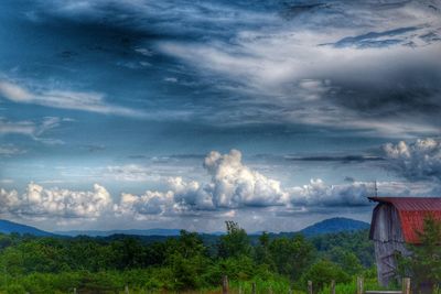 Scenic view of landscape against cloudy sky