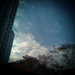 Low angle view of building against cloudy sky