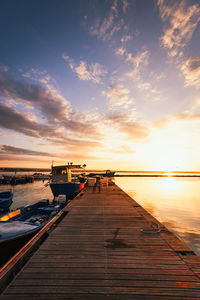 Pier over sea against sky during sunset