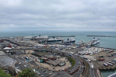 Aerial view of highway by sea against sky