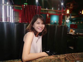 Portrait of smiling woman sitting in restaurant