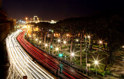 High angle view of light trails on two lane highway during night