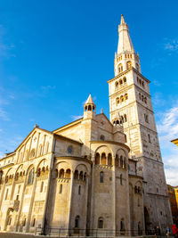 The ghirlandina, the bell tower of modena italy and the wonderful romanic dome against the blue sky