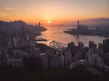 High angle view of city buildings against sky during sunset