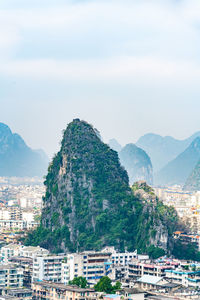 High angle view of townscape and mountains against sky