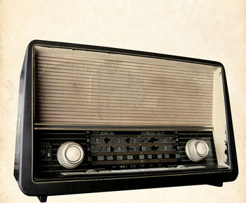 Close-up of old radio against wall