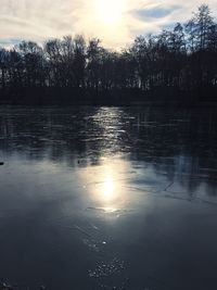 Scenic view of lake against sky at sunset