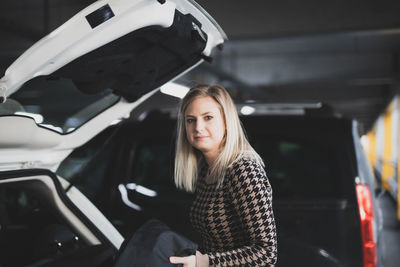 Portrait of young woman in car