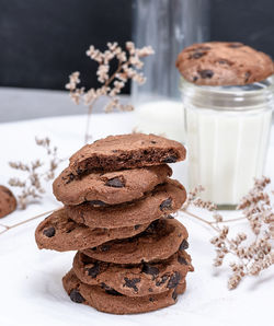 Close-up of cookies and milk glass on table