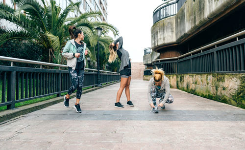 Rear view of people walking on street