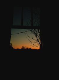 Silhouette trees against sky at sunset