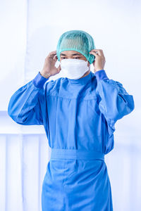 Doctor wearing mask against white background