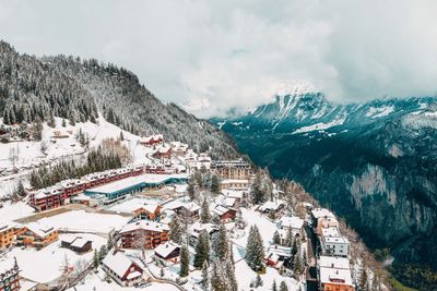 High angle view of townscape and snowcapped mountain against sky