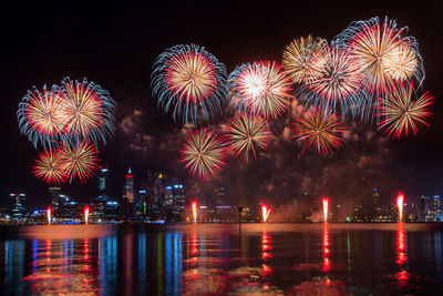 Firework display in city at night