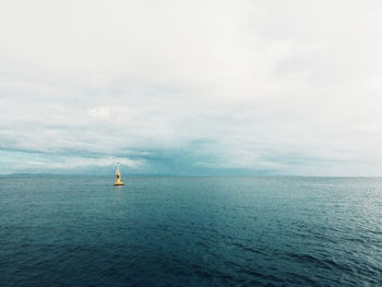 Boat sailing in sea against sky