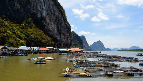 Boats moored in sea against sky