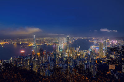 High angle view of illuminated cityscape against sky at night