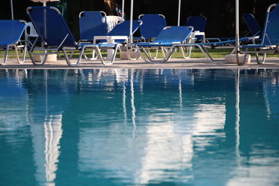 Deck chairs arranged at poolside