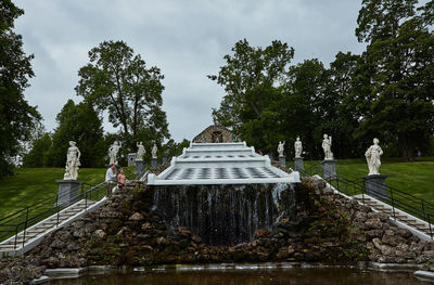 Statue amidst trees against sky