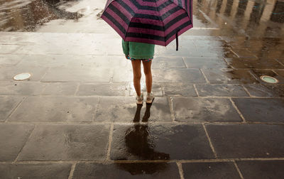 Low section of child under an umbrella 