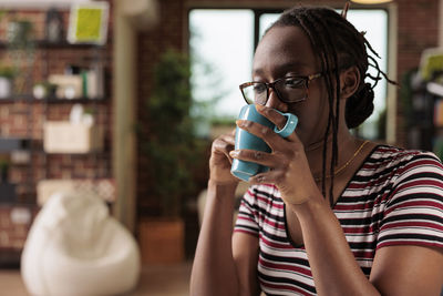 Young woman drinking glass