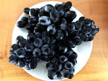 High angle view of blackberries in plate on table