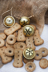 Dog treats with christmas ornaments on neutral tabletop