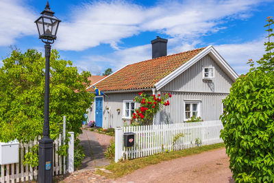Street amidst houses and buildings against sky