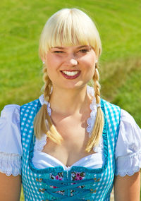 Portrait of smiling young woman wearing dirndl
