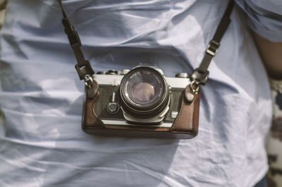 High angle view of camera on bed