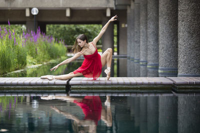 Woman with arms raised in lake