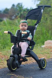 High angle view of boy riding push scooter on field