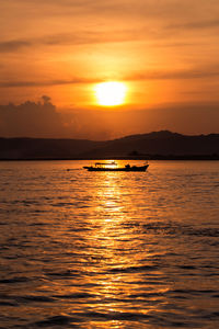 Scenic view of sea against orange sky