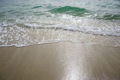 High angle view of waves rushing towards shore